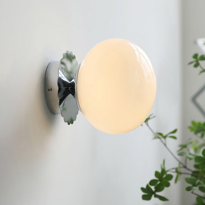 Detailaufnahme der Blütenform-Halterung einer modernen Wandlampe.